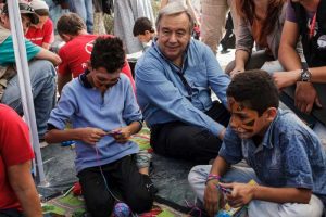 UN High Commissioner for refugees António Guterres sits among two young boys from Syria in a play area at the Moria Identification Centre, Lesvos. © UNHCR/A. Zavallis