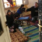 Mohammed and his family gather on the floor of their dilapidated apartment in downtown Amman. Two of his children are living with disability. The family receive 100 Jordanian dinars (US$140) a month in cash assistance from UNHCR, but after paying for electricity and gas they rely entirely on vouchers from the World Food Programme to cover all their other expenses. © UNHCR/B.Szandelszky