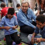 UN High Commissioner for refugees António Guterres sits among two young boys from Syria in a play area at the Moria Identification Centre, Lesvos. © UNHCR/A. Zavallis